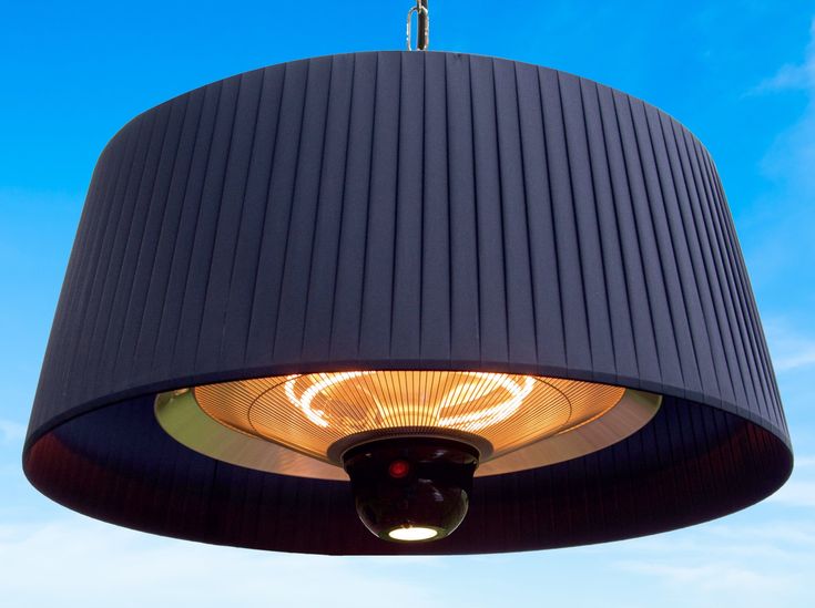 a black lamp hanging from the ceiling with a blue sky in the backgroud