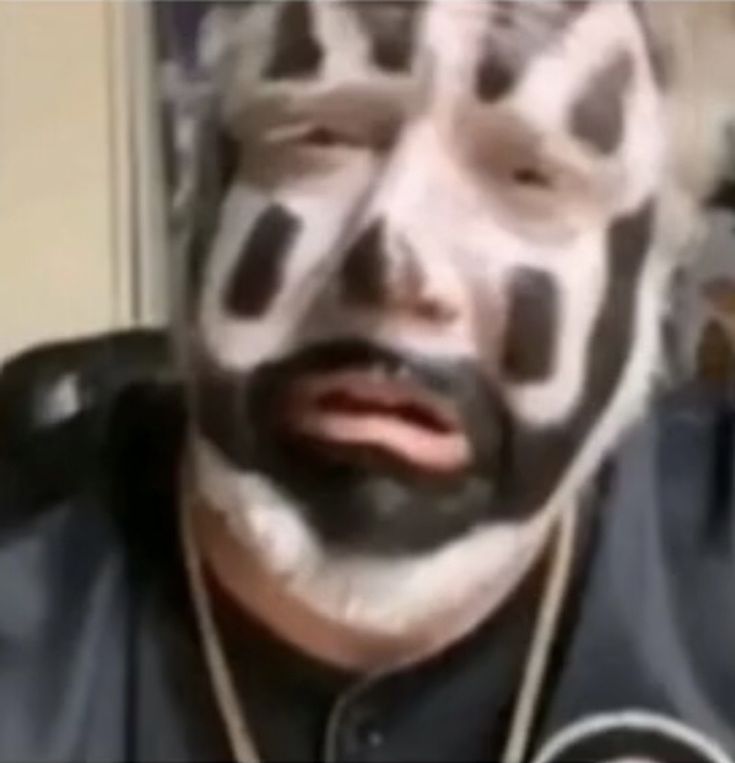 a man with his face painted in black and white