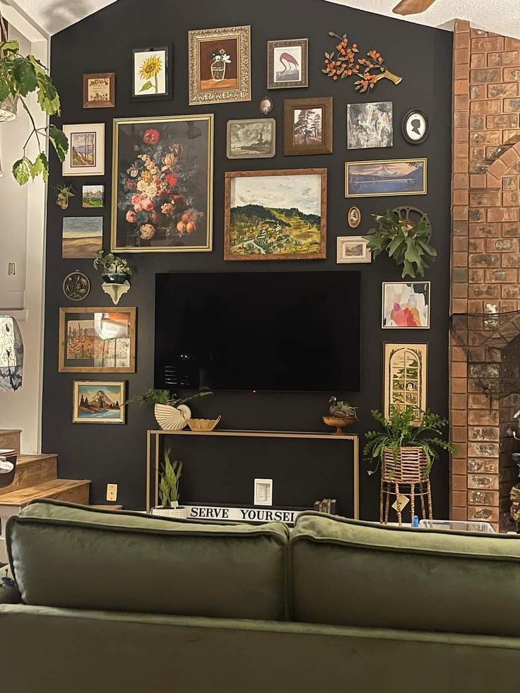 a living room filled with furniture and pictures on the wall above a flat screen tv