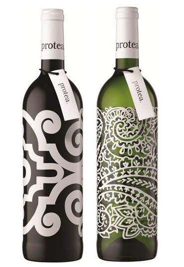 two bottles of wine with designs on them