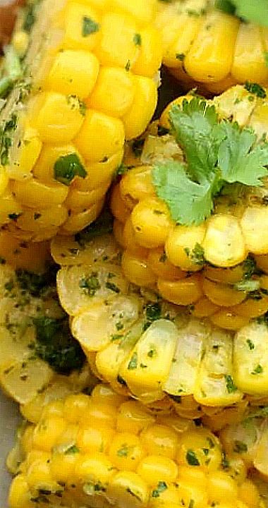 grilled corn on the cob with cilantro and parsley garnish