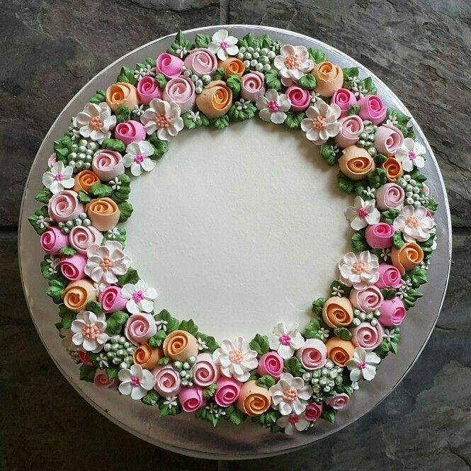 there is a cake decorated with flowers on the table