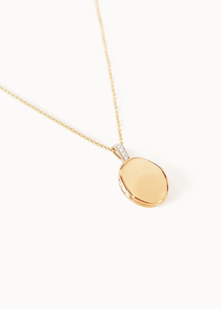 Home is where the heart is. Our Maison Gold Lockets are heirlooms that represent a moment in time. Keep this locket as a family heirloom forever. Wear her blank or get her engraved with your signature letter. To engrave more than one letter, visit HERE.Already have a chain? To purchase the locket individually, visit HERE. Photo dimensions: 14mm x 11.5mmTo add a photo inside, simply open the locket and carefully press the photo into place. Our lockets do not have a separate opening for a photo. F Luxury Locket Jewelry For Keepsake, Luxury Keepsake Medallion Necklace, 14k Gold Oval Link Locket Jewelry, Classic Oval Link Locket Necklace, Luxury Polished Pendant Locket Necklace, Timeless Oval Locket Necklace For Gift, Elegant Diamond Locket Jewelry, Timeless Oval Pendant Diamond Necklace, Classic Oval Link Locket Jewelry