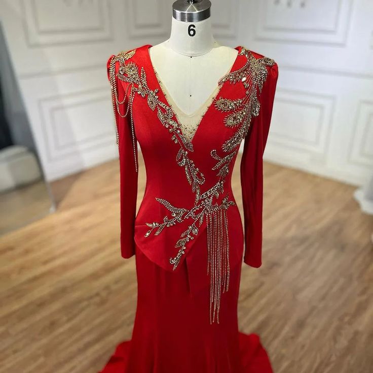 a red evening gown on display in a room