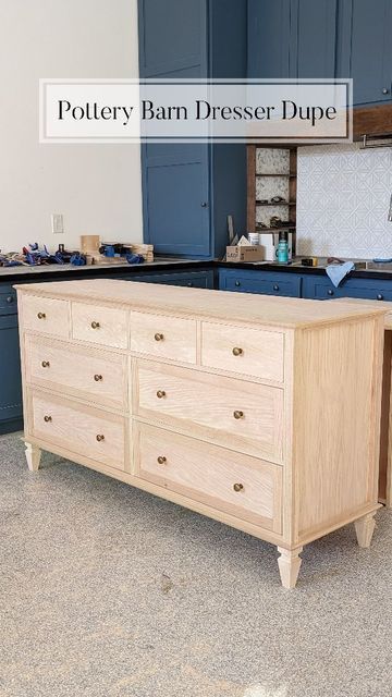 a large wooden dresser sitting in a kitchen next to a stove top oven and cabinets