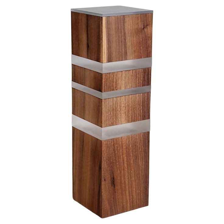 a tall wooden object with metal strips on it's sides and wood grain in the middle