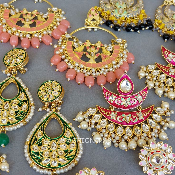 5 pair of assorted golden-toned Traditional Handmade Meenakari Earring for Women with hanging pearls.
 
 Size & Other Details
 Material  : Alloy, Pearl, Meena work
 Attire :  Lehenga Choli, Salwar Suit, Kurti, Saree, Flared Dress
 Pieces : 5pc
 
 Assorted design will come depending on the stock available. Meenakari Hoop Earrings For Celebrations In Temple Jewelry Style, Meenakari Hoop Earrings For Celebration, Kundan Hoop Earrings Temple Jewelry Gift, Heavy Pearl Earrings For Festivals Gift, Kundan Tilla Hoop Earrings As Gift, Heavy Pearl Earrings For Festivals, Meenakari Temple Jewelry Hoop Earrings For Celebration, Temple Style Chandbalis For Festivals, Meenakari Chandbali Pearl Earrings As Gift