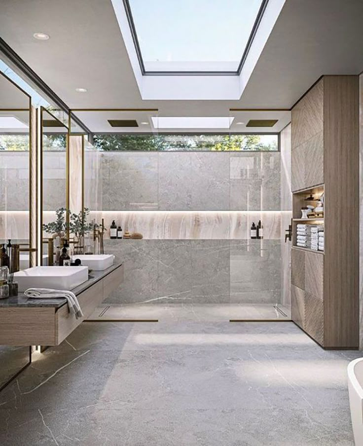 a large bathroom with two sinks and a skylight in the ceiling, along with a bathtub