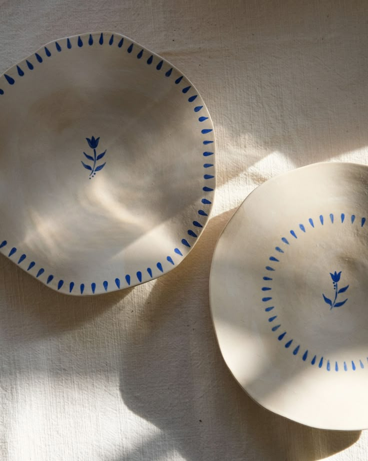 two plates sitting on top of a white table cloth