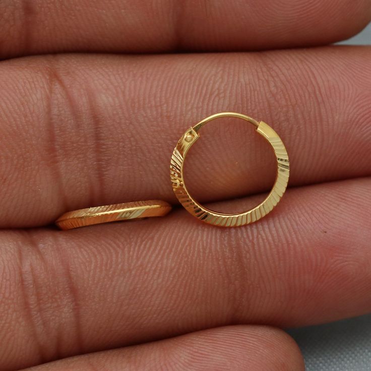 20kt 20 karat small hoop cartilage yellow gold Hoop Bali earrings  Gold Purity- 20k yellow Gold Weight - 0.98 grams approx Full Length - 1.3 cm approx Full Width - 1.3 cm approx click to see similar  https://www.etsy.com/in-en/shop/morvijewels?ref=seller-platform-mcnav Click here  https://morvijewels.etsy.com/    to get more discount and offers Happy to take wholesale bulk orders. Single Round Huggie Earring For Gift, Dainty Gold Hoop Cartilage Earrings, Dainty Gold Diamond Cut Hoop Earrings, Yellow Pierced Hoop Earrings As Gift, Anniversary Yellow Gold Plated Cartilage Earrings, Single Yellow Gold Huggie Earring As Gift, Handmade Gold Small Hoop Nose Rings, Gold Plated Yellow Gold Hoop Cartilage Earrings, Handmade Small Hoop Gold Nose Rings