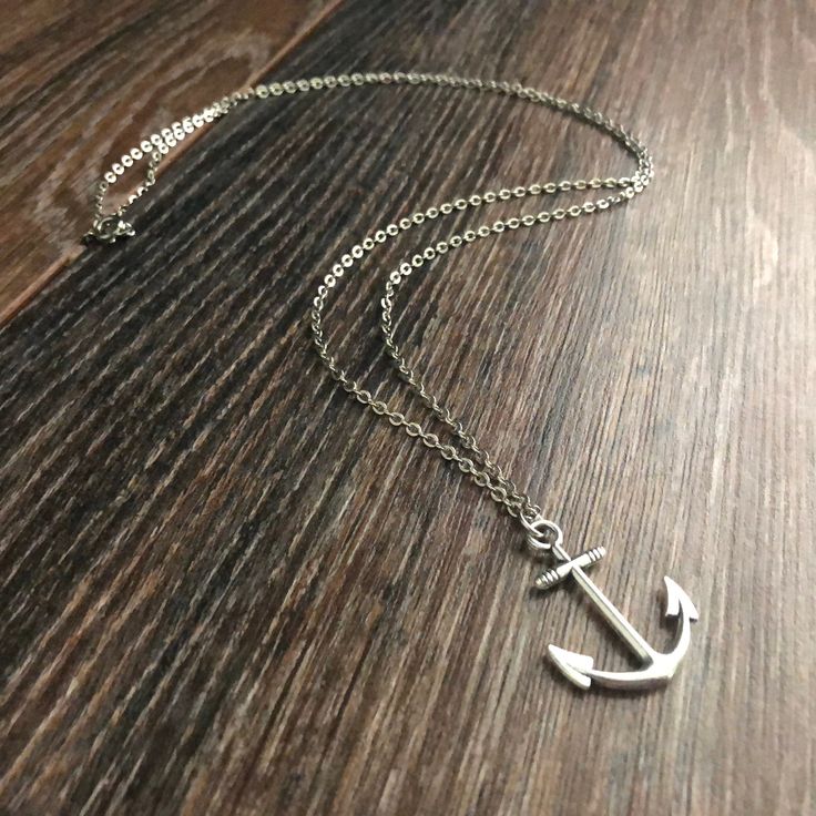 "Item Overview: - 1\" Tibetan Silver Proudmoore Anchor Pendant. - Matching Silver Chain (30\"). Item Details: This handsome anchor pendant is a tribute to Kul Tiras and Lady Proudmoore. It measures in at one inch and is a good weight so it can be worn everyday without it feeling heavy or getting in the way. Each anchor pendant comes on a matching silver 30\" cable link specialty chain and makes a great gift for a fan or anyone with a connection to the sea! For the alliance! Conversation and Ship Everyday Nautical Anchor Jewelry, Silver Anchor Necklace Nautical Style, Silver Stainless Steel Anchor Necklace, Silver Anchor-shaped Nautical Jewelry, Silver Nautical Anchor Jewelry, Stainless Steel Anchor Necklace For Gift, Stainless Steel Anchor Necklace For Gifts, Everyday Silver Anchor Jewelry, Everyday Silver Jewelry With Anchor Shape