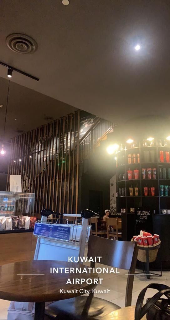 the interior of an international airport with tables and chairs