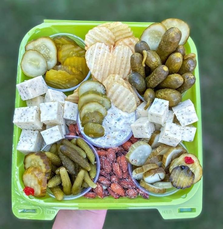 a green tray filled with different types of food