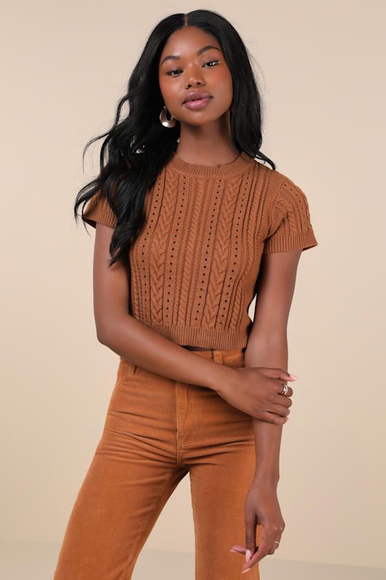 Your autumn style will be truly special a with trendy must-have like the Lulus Modish Ways Rust Brown Cable Knit Short Sleeve Sweater Top! This soft and stretchy sweater boasts a variety of classic designs, including cable, seed, and ribbed knit textures (plus pierced detailing), that makes this piece truly unique. A timeless crew neckline and a fitted, cropped bodice are framed by cute short sleeves, while contrasting ribbed knit trim at the neckline, cuffs, and hem completes the look. Fit: Thi Trendy Cable Knit Crew Neck Top, Trendy Crew Neck Cable Knit Top, Trendy Pointelle Knit Cropped Sweater For Fall, Brown Cable Knit Tops For Layering, Brown Cable Knit Crew Neck Top, Fall Cropped Cable Knit Sweater With Stretch, Brown Crew Neck Knit Top For Layering, Trendy Cropped Pointelle Knit Top, Fitted Cable Knit Cropped Sweater For Layering