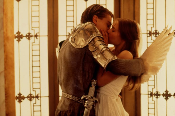 a man in armor kissing a woman on the cheek