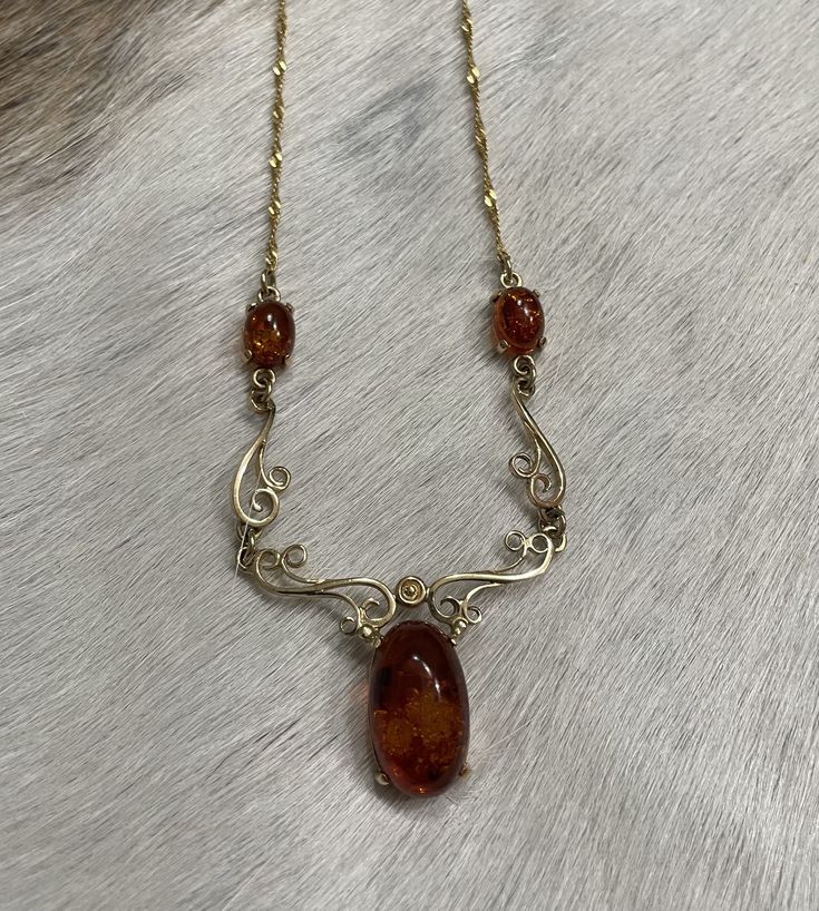 This stunning piece comes to us from Europe. The main Amber Stone is about 5/8 of inch long. The two smaller amber stones are approximately 1/4 inch long. The necklace is 14k and is approximately 17.5 inches in length. Pre-owned. Marked 585. Simply stunning and reminiscent of a by gone era. Layaway-All regular priced items can be placed on layaway with payment plans between 2 and 6 payments, depending on the cost of the piece. The 1st payment of the layaway is due on the day of the agreed layawa Amber Necklace, Amber Stone, Wedding Jewellery Necklace, Wedding Necklace, Antique Style, Vintage Necklace, Hair Inspo, Sale Items, Brown Hair