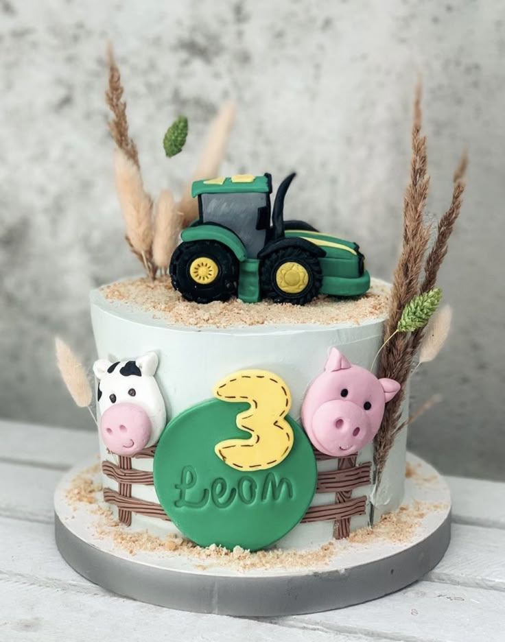 a cake decorated with farm animals and tractors