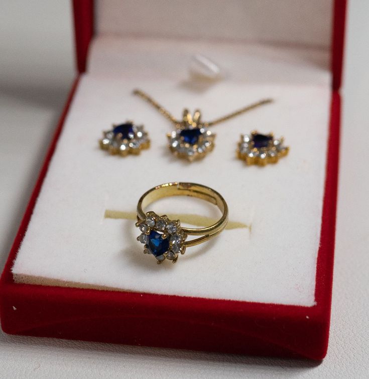 "Beautiful birthstone heart 3-piece set in gift box September/simulated sapphire Set included 16\" gold plated Chain with 3\" adjuster pendant around 3/4\" long round post earrings 1/2\" in diameter ring size 6 adjustable red velvet gift box Great condition" Avon Rings, Opal Jewelry Set, September Sapphire, Yellow Gold Cocktail Ring, Gold Cocktail Ring, Avon Jewelry, Gold Cocktail, Silver Jewellery Sets, Rhinestone Ring