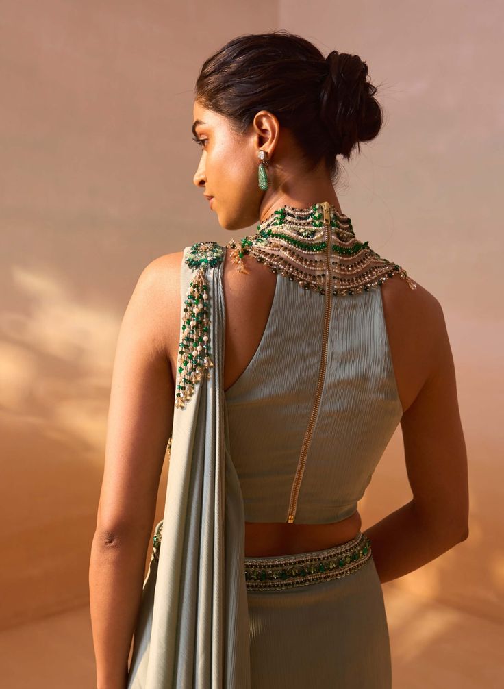 Sage green satin pre-draped sari paired with a jeweled high-neck embroidered blouse, creating a stunning and elegant ensemble. Indian Style Wedding, Gorgeous Lehengas, Halter Neck Blouse, Unique Saree, Halter Neck Blouses, Draped Saree, Green Sleeveless Blouse, Net Embroidery, Saree Draping Styles