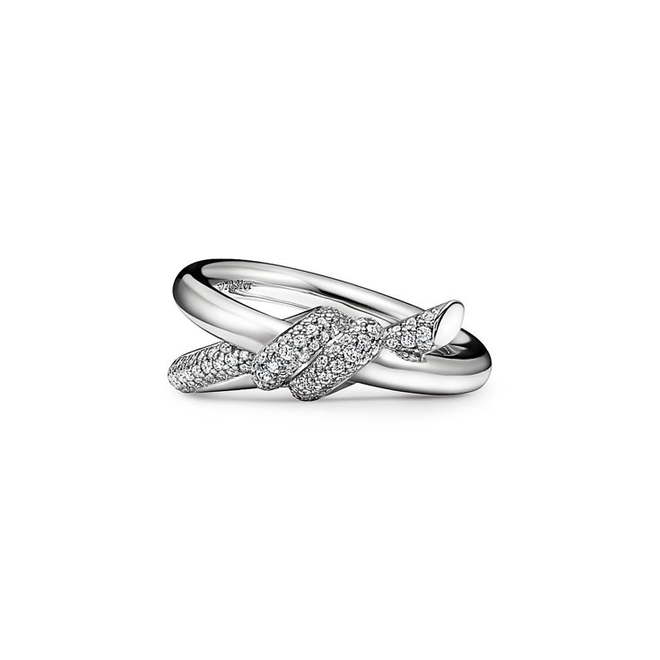 The entwined ends of Tiffany Knot’s signature motif symbolize the power of connections between people. Balancing strength and elegance, each Tiffany Knot design is a complex feat of craftsmanship. This ring is crafted with white gold and polished by hand for high shine. Each round brilliant diamond—specifically chosen to meet Tiffany’s high standards—is hand set at precise angles to maximize brilliance. Wear this ring on its own or partnered with classic silhouettes for an unexpected pairing. 18 Tiffanys Ring, Tiffany Co Ring, Tiffany Ring Stack, Tiffany Stackable Rings, Tiffany Knot, Tiffany Knot Ring, Tiffany Pave Ring, Tiffany And Co Rings, Tiffany Ring