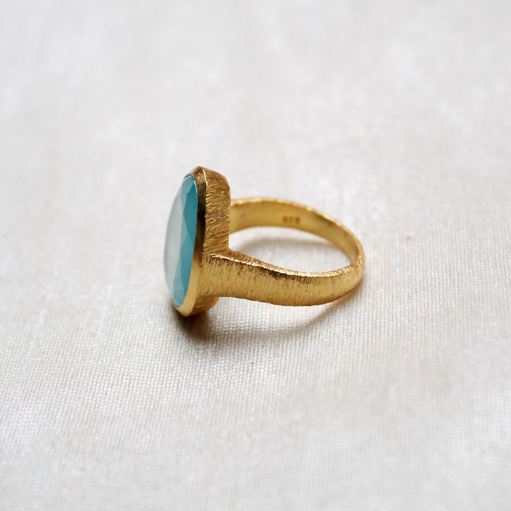 D E T A I L S - Material: 925 Sterling Silver Stone: Aqua Chalcedony The fit: True to US ring size Finish: Textured and Gold Plated to a high shine Upgrade your accessory collection today with this must-have piece, & flaunt your style statement S H I P P I N G & P R O D U C T I O N - My current production time is 2-6 business days, which means after those days are up, your order ships! I make everything custom to order, by hand, but I promise you it's worth the wait! R U S H - M Y - O R Handmade Gold Chalcedony Rings, Adjustable Round Chalcedony Ring, Green Turquoise Cabochon Ring, Silver-setting Turquoise Cabochon Ring, Aqua Chalcedony Ring, Chalcedony Ring, Textured Ring, Aqua Chalcedony, Everyday Rings