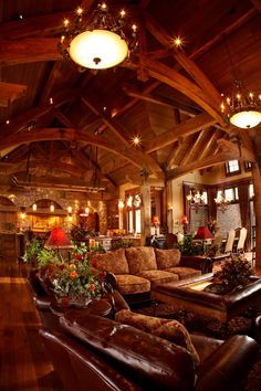 a living room filled with furniture and lots of lights hanging from the ceiling above it