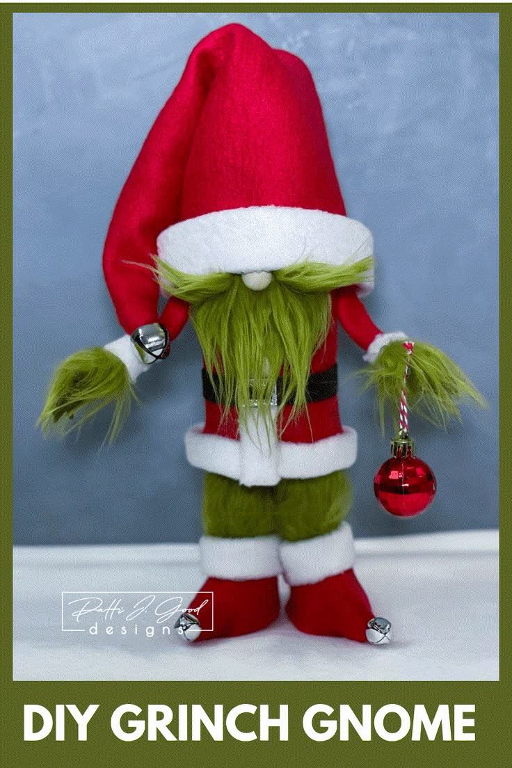 the grinch gnome is holding a christmas ornament