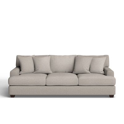 an image of a couch with pillows on the top and bottom part, in front of a white background