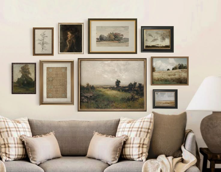 a living room filled with lots of pictures on the wall above a couch and lamp