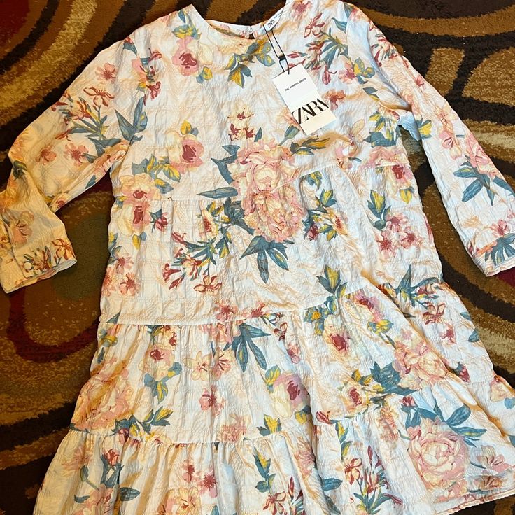 Brand New Casual Floral Print Dress For Daywear, Casual Long Sleeve Floral Dress For Dress Down Occasions, Spring Daywear Dress With Ruffle Hem, Casual Long Sleeve Mini Dress For Garden Party, Casual Floral Dress With Ruffle Hem For Daywear, Spring Long Sleeve Floral Dress With Ruffle Hem, Spring Floral Dress With Ruffle Hem And Long Sleeves, Zara Casual Sundress With Ruffles, Zara Midi Dress For Spring Vacation