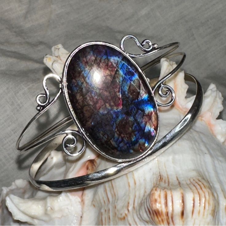 Artisan Designed & Handcrafted Aurora Borealis Blue Flash Labradorite Gemstone Handcrafted Cuff * Flashes Of Fire: Red, Blue, Purple And Gold * Circumference On Cuff Is 7.5-8.5” With 1” Adjustable Spacing * Hand Crafted 925 Sterling Silver Simulated The Flashes In The Aurora Borealis Labradorite Is A Member Of The Feldspar Family And Is Treasured For Its Remarkable Play Of Color. The Flashes Of Color, A Phenomenon Called Labradorescence. The Stone, Usually Gray-Green, Dark Gray, Black, Or Grayis Adjustable Labradorite Cuff Bracelet As Gift, Unique Labradorite Cuff Bracelet As Gift, Unique Handmade Labradorite Cuff Bracelet, Blue Gemstone Cuff Bracelet, Unique Blue Oval Cuff Bracelet, Bohemian Adjustable Cabochon Cuff Bracelet, Adjustable Bohemian Cuff Bracelet With Cabochon, Bohemian Oval Gemstone Cuff Bracelet, Unique Oval Gemstone Cuff Bracelet