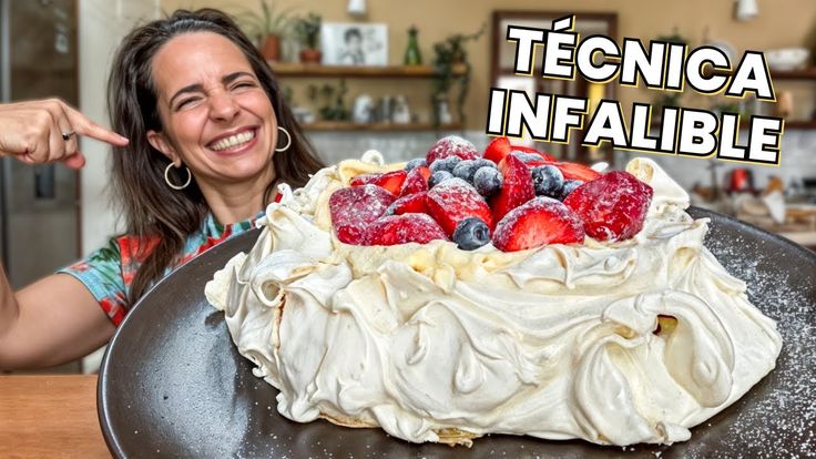 a woman pointing at a cake with strawberries and blueberries on it