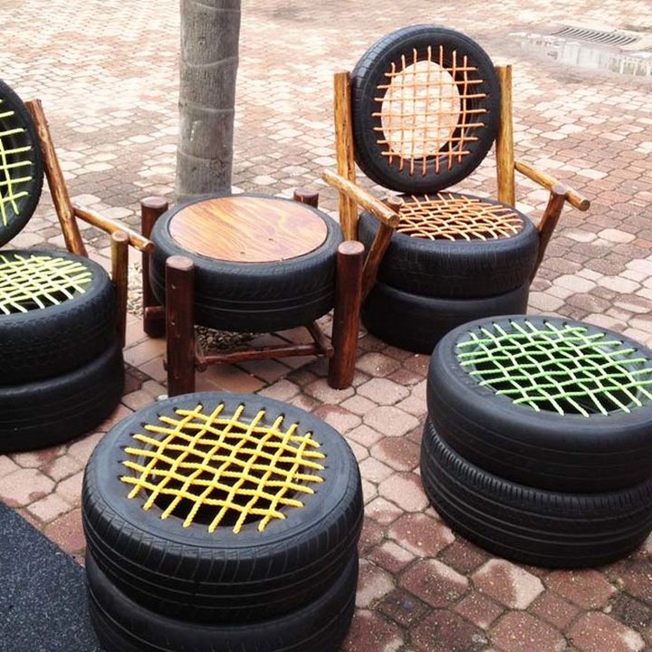 four chairs made out of old tires sitting next to each other on a brick sidewalk