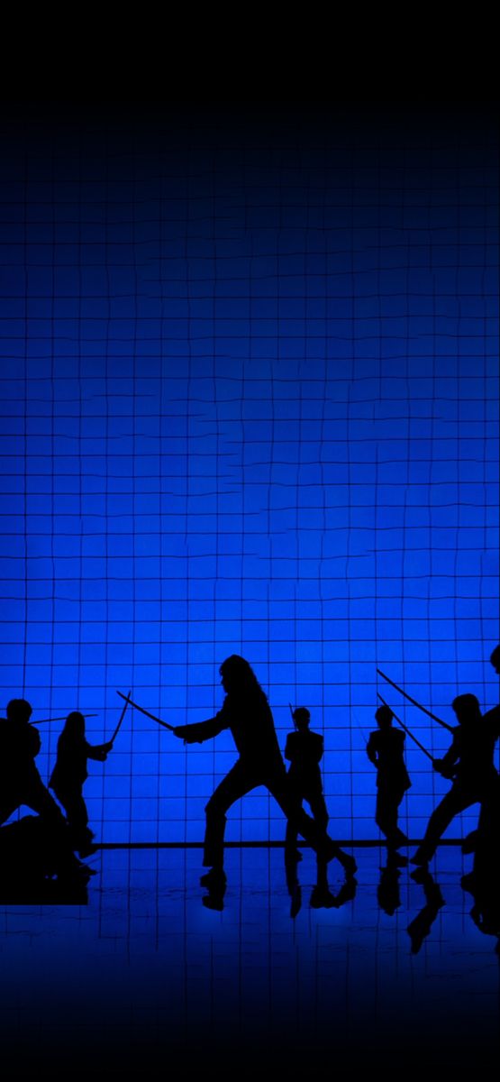 the silhouettes of people are dancing in front of a blue wall with black netting