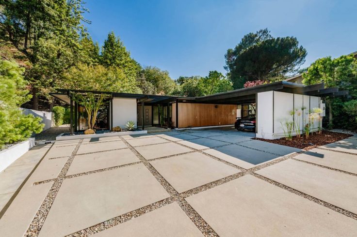 a modern house in the middle of a wooded area