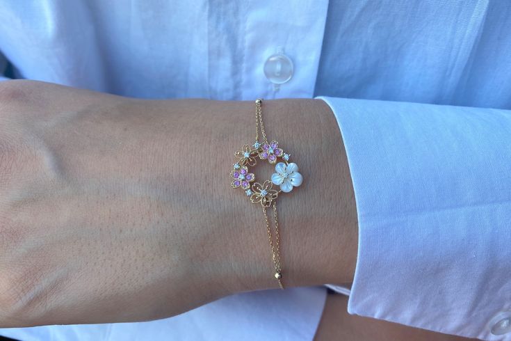 "Flower Bracelet, Unique Diamond and Sapphire Flower Bracelet, 14k Gold Diamond Bracelet, Solid Gold Dainty Diamond Bracelet, Gifts For Her A real present for yourself or someone else! This lovely 14k solid gold necklace with 1 dainty flower, 10 sapphire stones and 9 diamonds. Bracelet length: 7inches.(can be personalized as your wish). Chain width: 0.85MM. Material: 14K solid yellow -, white-, or rosegold. Diamonds: 0.09 ct. White Diamond G Color SI-VS Clarity. Sapphires: 0.16 ct. Pink Sapphire Delicate Yellow Gold Flower Bracelet, Dainty White Gold Flower Bracelet, Delicate Floral Bracelet For Formal Occasions, Dainty Yellow Gold Bracelet With Flower Charm, Suede Box, Diamonds Bracelet, Gold Diamond Bracelet, Sapphire Stones, Solid Gold Necklace