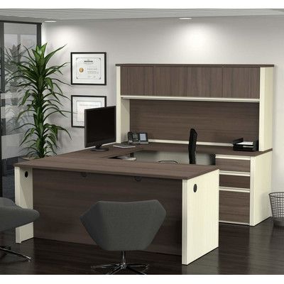 an office cubicle with desk, chair and computer