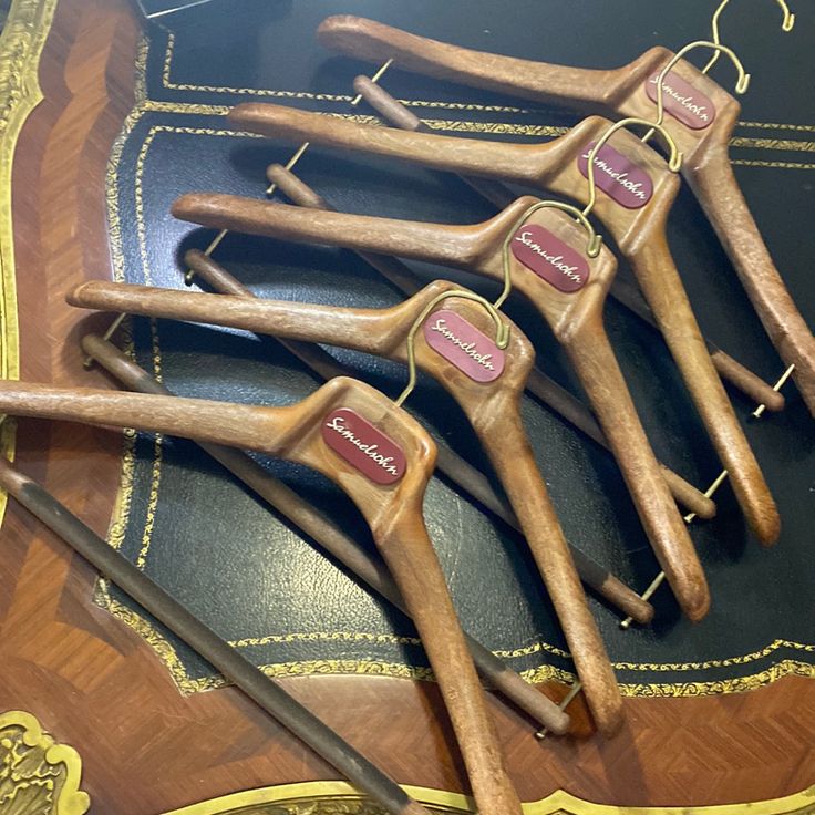 five wooden toothbrushes are lined up on a table