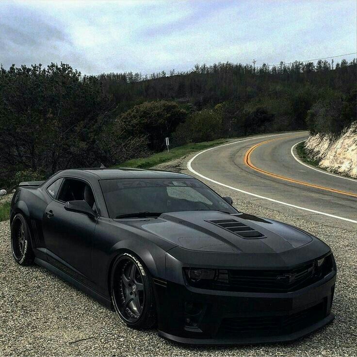 a black sports car parked on the side of a road