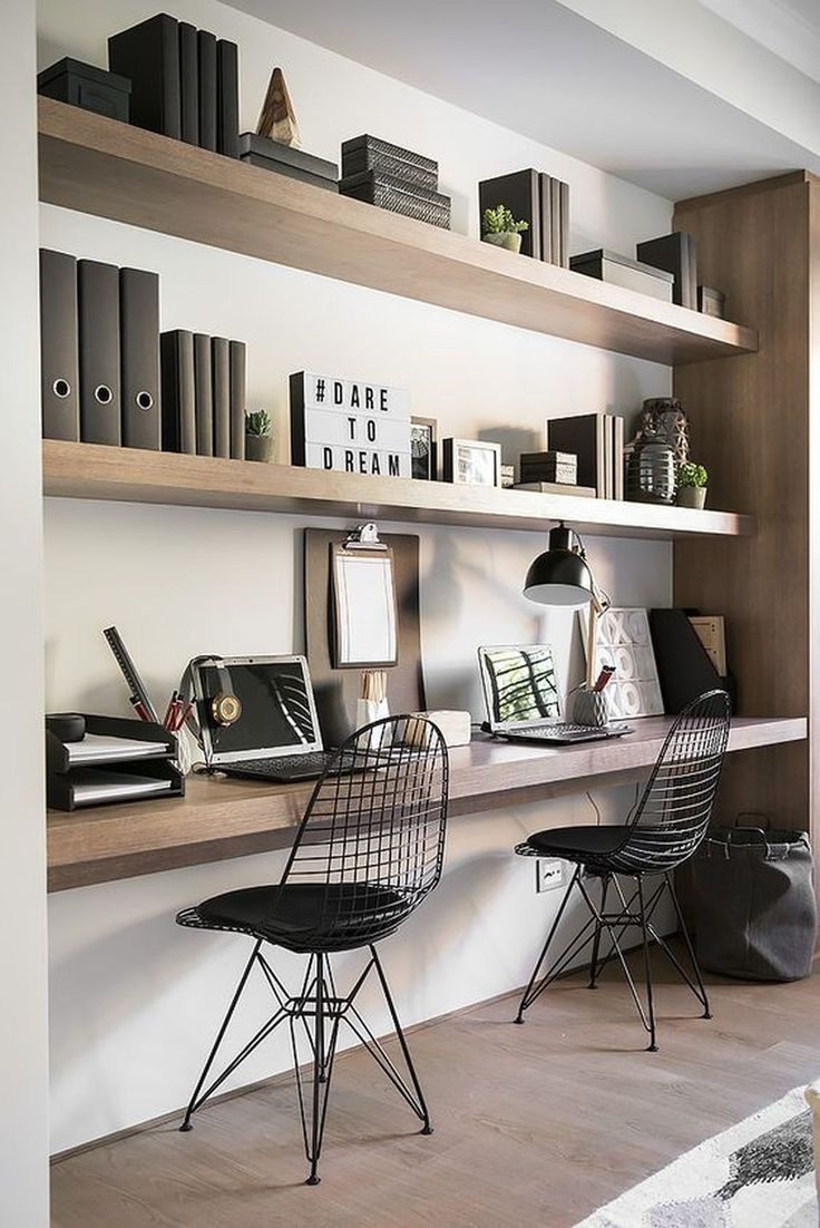 two black chairs sitting in front of a book shelf filled with books and other items