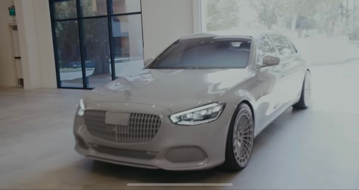 a grey car parked in front of a large window