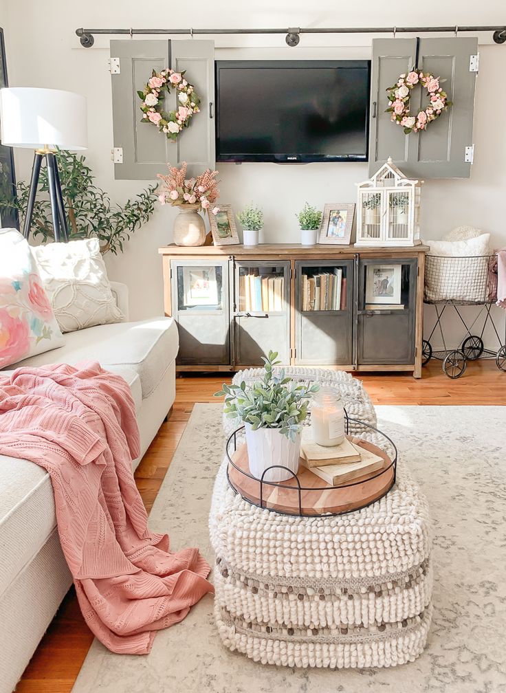 a living room filled with furniture and a flat screen tv mounted to the side of a wall