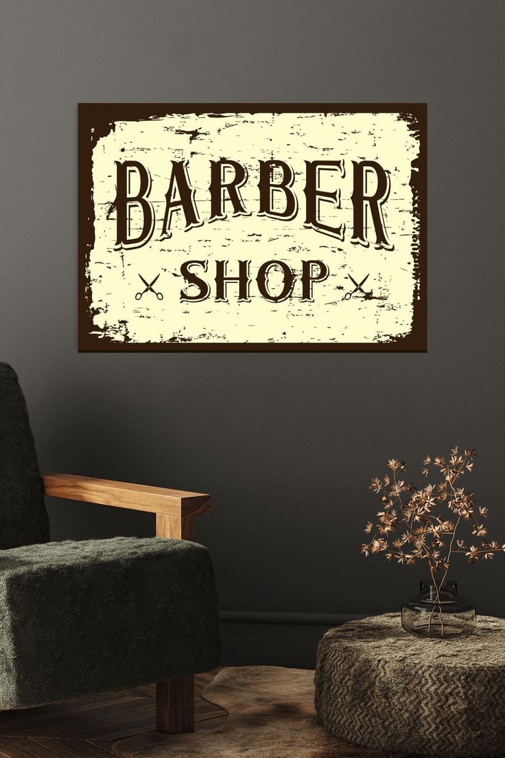 a barber shop sign hanging on the wall next to a chair and ottoman in a living room