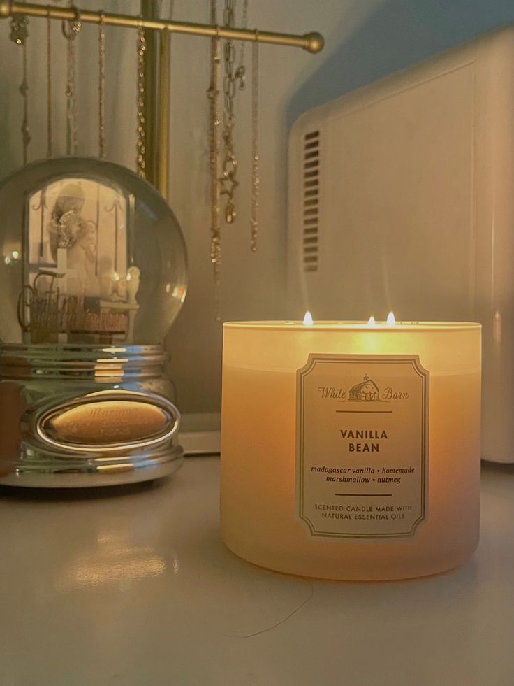 a candle sitting on top of a counter next to a microwave