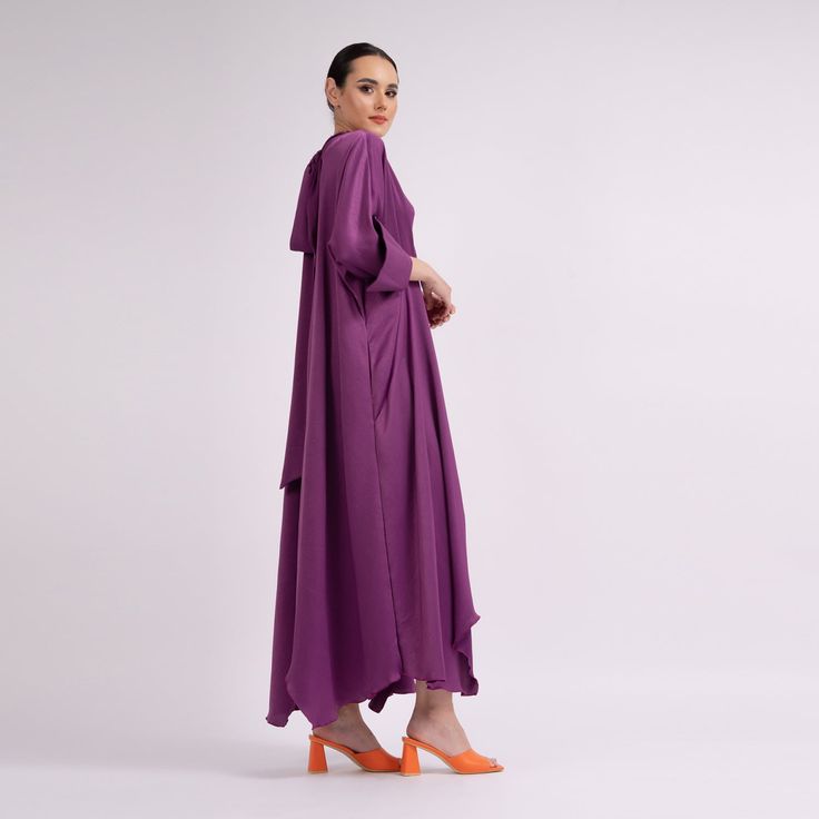 Maxi dress with long sleeves, wide cuffs and 'V' neckline and scarves which can be tied on the back of the neck, made in metallic fabric. Dry clean only. Silk Dress With Gathered Long Sleeves, Eid Evening Dresses With Draped Sleeves, Evening Long Sleeve Maxi Dress With Draped Sleeves, Elegant Long Sleeve Silk Dress With Draped Sleeves, Long Sleeve Purple Party Kaftan, Dress With Draped Sleeves For Party And Eid, Elegant Purple Evening Kaftan, Party Dresses With Draped Sleeves For Eid, Elegant Long Sleeve Formal Kaftan