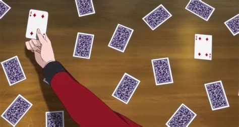 a person reaching for playing cards on a table with many squares and dots all over them