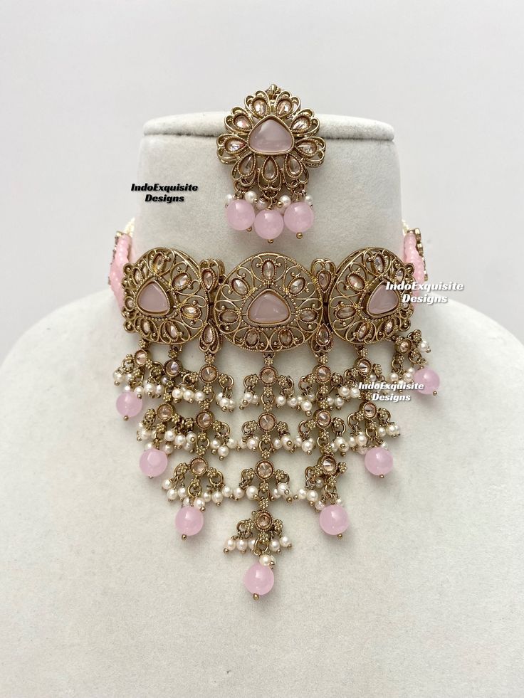 Elegant antique gold Polki pearls Choker Set with beautiful Jhumki earrings and Tikka/Indian Jewelry/ High quality kundan Polki jewelry/trendy choker/baby pink     All items are shipped from Brampton, Ontario, Canada. If you need your item by a certain day, please reach out to us for express delivery option before placing the order so that we can update the shipping for you. Standard shipping/delivery timeline Below are the estimated delivery times after the order is shipped/dispatched.  ---> US Handmade Pink Kundan Necklace For Gift, Pink Elegant Kundan Tikka, Temple Jewelry With Intricate Design In Pink, Elegant Pink Kundan Tikka, Pink Tilla Jewelry Sets For Wedding, Pink Round Jewelry With Stone Work, Handmade Pink Temple Jewelry Sets, Pink Temple Jewelry With Intricate Design, Elegant Pink Meenakari Jewelry