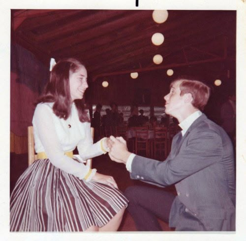 an old photo of a man and woman dancing