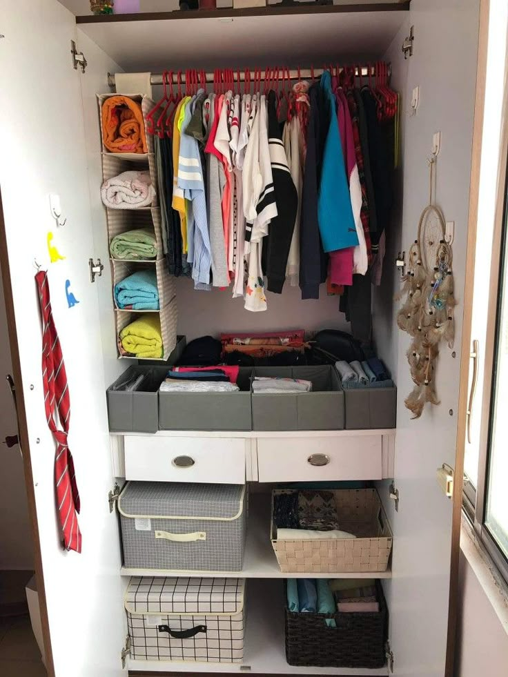 an organized closet with clothes and other items