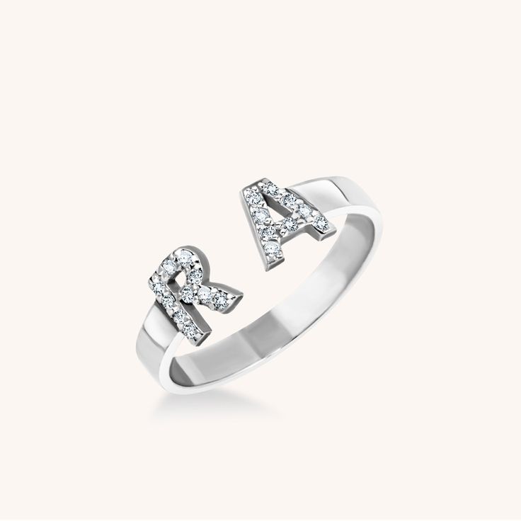 A double dose of sans serif initials covered in pavé diamonds makes a beautiful big little statement. Classic Diamond Initial Ring With Monogram, Classic Diamond Monogram Initial Ring, Classic White Gold Diamond Ring With Initials, Anniversary Jewelry With Initials In Diamond White, Diamond White Jewelry With Initials For Anniversary, Classic Diamond Initial Ring Personalized, Classic Personalized Diamond Initial Ring, Classic Diamond Monogram Rings, Sterling Silver Initial Ring With Diamond Accents For Wedding